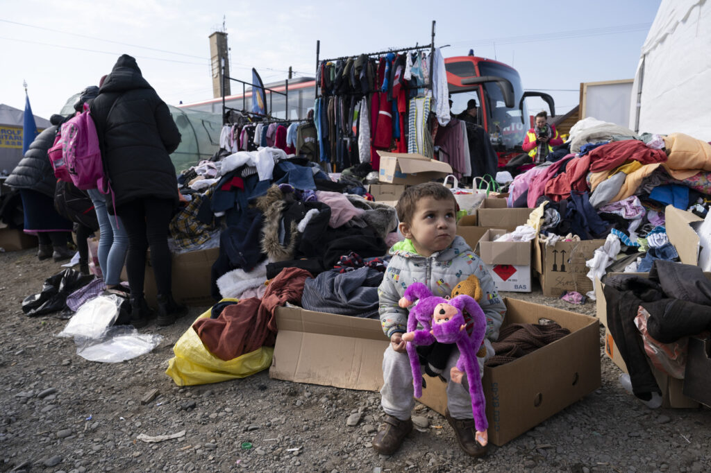A Ukrainian child holds a donated stuffed animal at a refugee station in the Polish border town of Medyka on March 15, 2022. Dozens of aid stations were set up in the area by non-profit organizations and charity groups to provide food, toys, clothes, and other necessities for refugees who had fled the Russian invasion of Ukraine. (Photo by Yang Tzu-lei)
